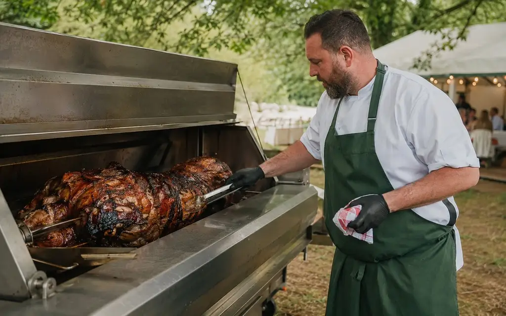 Chef tending a new outdoor hog roaster